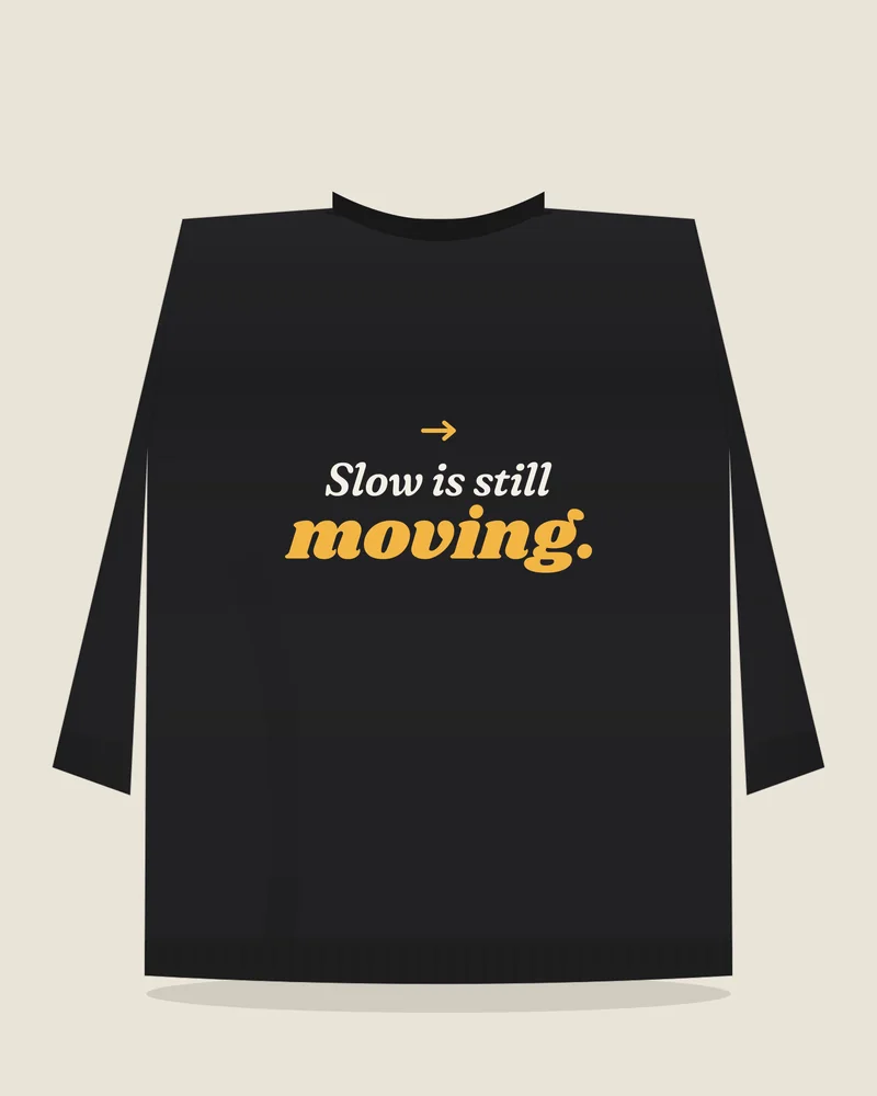 Black crewneck sweatshirt with the print “Slow is still moving.”, back view (illustration)