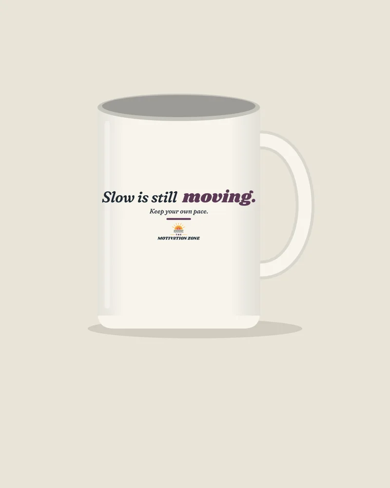 White mug with the print “Slow is still moving.”, view (illustration)
